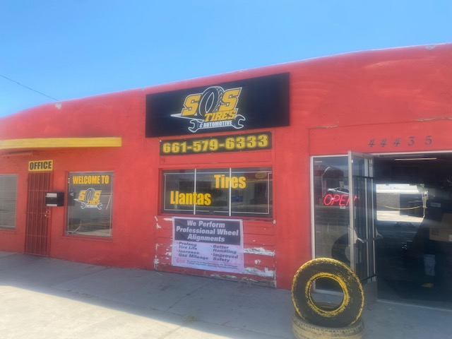 The S.O.S. Tires storefront showing the We Perform Professional Wheel Alignments sign