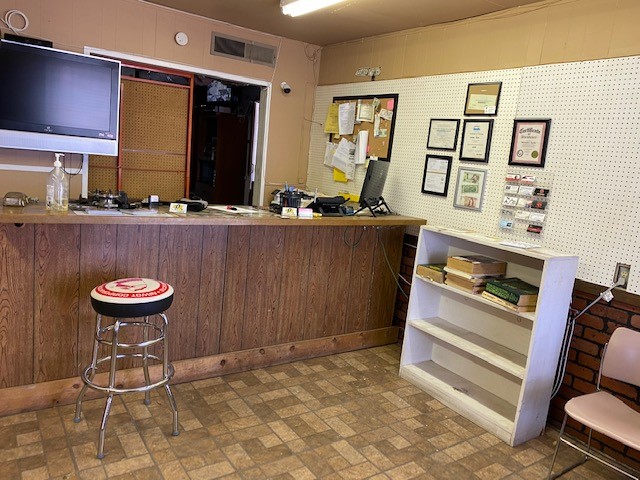 The office at S.O.S. Tires, wood counter and framed certificates on the wall